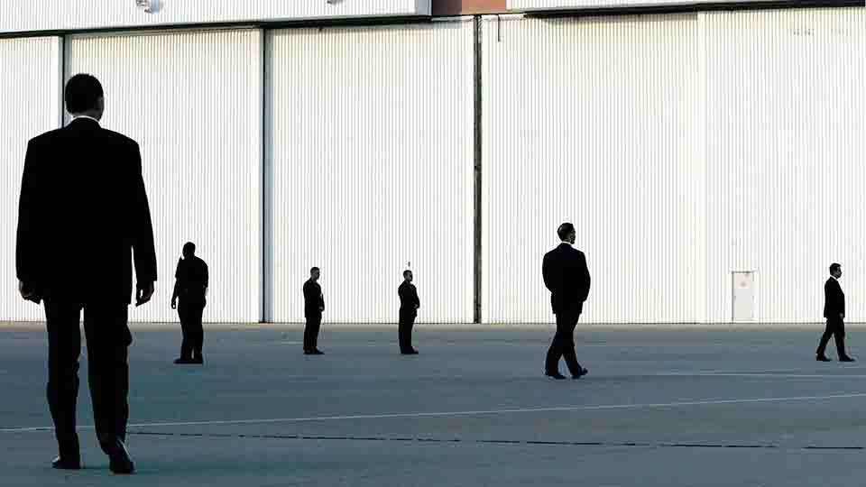 U.S. Secret Service agents walk on the tarmac before the arrival of U.S. President George W. Bush on Marine One in Waco, Texas, August 7, 2002.