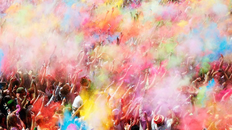 People throw coloured powder during the Holi festival in Barcelona April 6, 2014.