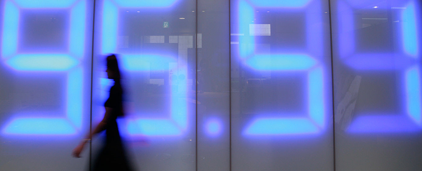 A woman walks past an image of the Japanese yen's exchange A woman walks past an image of the Japanese yen's exchange rate against the U.S. dollar projected on a wall at a foreign exchange retail trading company in Tokyo October 29, 2008.
