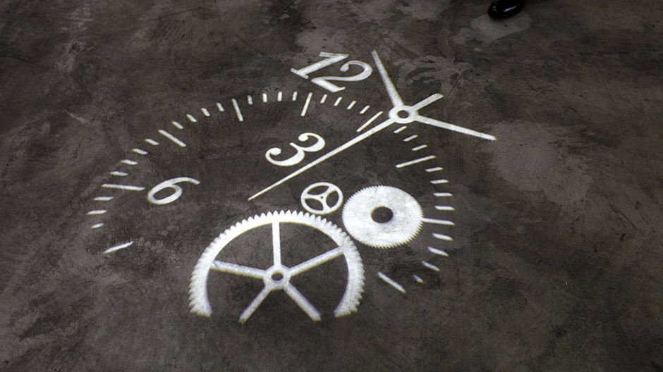 A clock is projected onto the floor at the Hong Kong Watch & Clock Fair September 2, 2009.