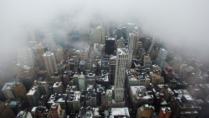 Low lying clouds from a snowstorm obscure the skyline of New York.
